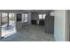 Bright living area featuring tiled floors, sliding glass doors to the patio, and open access to the kitchen at 4037 Chalfont Ct, Las Vegas, NV 89121
