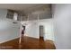Open living area with wood floors, staircase, white railings, high ceilings, and large windows allowing ample light at 4037 Chalfont Ct, Las Vegas, NV 89121