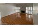 Bright living room features wood floors, a fireplace, shuttered windows, and natural light, creating an inviting space at 4037 Chalfont Ct, Las Vegas, NV 89121