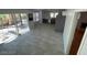 Bright living space with tile flooring, access to a patio, open layout to kitchen, and ample natural light at 4037 Chalfont Ct, Las Vegas, NV 89121