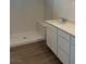 Bathroom featuring a walk-in shower, modern vanity with countertop, and wood flooring at 4145 Texas Lilac Ave, Las Vegas, NV 89139