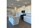 Modern kitchen with an island, stainless steel appliances, and white cabinetry at 4145 Texas Lilac Ave, Las Vegas, NV 89139