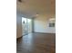 Spacious living room with wood flooring and sliding glass door to the backyard at 4145 Texas Lilac Ave, Las Vegas, NV 89139