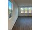 Bright living room featuring wood flooring and multiple windows offering natural light at 4145 Texas Lilac Ave, Las Vegas, NV 89139