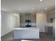Modern kitchen features a center island, stainless steel appliances, and grey cabinets at 4153 Texas Lilac Ave, Las Vegas, NV 89139