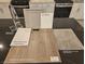 Kitchen design elements showcase a modern countertop, gray cabinets, vinyl plank flooring, and chrome faucet at 4153 Texas Lilac Ave, Las Vegas, NV 89139