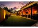 Inviting backyard featuring a covered patio with outdoor seating, lighting, and artificial turf at 4211 Saxton Green Ave, Las Vegas, NV 89141