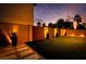 Tranquil backyard with modern landscaping, featuring artificial turf and ambient lighting at 4211 Saxton Green Ave, Las Vegas, NV 89141