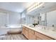 Bright bathroom with double sinks, a soaking tub, and a glass-enclosed shower for a spa-like experience at 4211 Saxton Green Ave, Las Vegas, NV 89141