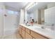 Bathroom with a vanity, double sinks, a large mirror, and an over-the-tub shower at 4211 Saxton Green Ave, Las Vegas, NV 89141