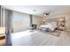 Bright, spacious bedroom with a large window, plush carpet, and a stylish modern seating arrangement at 4211 Saxton Green Ave, Las Vegas, NV 89141