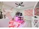 Bright bedroom featuring a modern ceiling fan and artistic wall decor over a geometric rug at 4211 Saxton Green Ave, Las Vegas, NV 89141