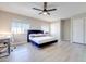 Stylish bedroom with a large window, closet, and a ceiling fan, offering comfort and natural light at 4211 Saxton Green Ave, Las Vegas, NV 89141