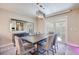 Stylish dining room with modern lighting, sleek furniture, and a sliding door to the backyard at 4211 Saxton Green Ave, Las Vegas, NV 89141