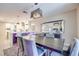 Open-concept dining area featuring modern light fixture and view of the kitchen and island seating at 4211 Saxton Green Ave, Las Vegas, NV 89141