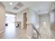 Bright hallway with light wood floors and elegant lighting near stairs, creating an inviting transition space at 4211 Saxton Green Ave, Las Vegas, NV 89141