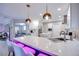 Bright, open kitchen features a large island with seating and modern pendant lighting at 4211 Saxton Green Ave, Las Vegas, NV 89141