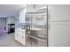 Bright kitchen showcases stainless steel refrigerator, white cabinets, and open layout at 4211 Saxton Green Ave, Las Vegas, NV 89141