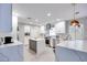 Bright, modern kitchen features white cabinetry, stainless steel appliances, and a large island at 4211 Saxton Green Ave, Las Vegas, NV 89141