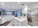 Spacious kitchen featuring white cabinets, stainless steel appliances, a center island, and modern finishes at 4211 Saxton Green Ave, Las Vegas, NV 89141