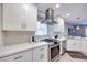 Contemporary kitchen featuring white cabinets, quartz countertops, and stainless steel appliances at 4211 Saxton Green Ave, Las Vegas, NV 89141