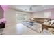 Spacious living room with a plush sectional sofa, a large rug, and sliding glass doors at 4211 Saxton Green Ave, Las Vegas, NV 89141
