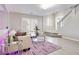 Cozy living room features a comfortable sofa, large windows, and a glass coffee table at 4211 Saxton Green Ave, Las Vegas, NV 89141