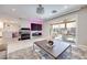 Bright living room featuring a modern design with a TV, wood floors and sliding glass doors at 4211 Saxton Green Ave, Las Vegas, NV 89141