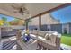Comfortable outdoor patio area with sofa seating, modern grill and a ceiling fan at 4211 Saxton Green Ave, Las Vegas, NV 89141