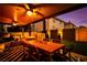 Beautiful covered patio featuring ample seating and a dining area at dusk at 4211 Saxton Green Ave, Las Vegas, NV 89141