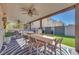 Covered patio with ceiling fans, outdoor seating, and a dining table creates an inviting entertaining space at 4211 Saxton Green Ave, Las Vegas, NV 89141