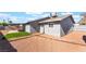 The backyard has gravel, artificial turf, and a covered patio at 4857 Fairfax Ave, Las Vegas, NV 89120