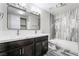 Bathroom boasts double sink vanity, modern fixtures, and tiled shower and floors at 4857 Fairfax Ave, Las Vegas, NV 89120