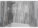 Modern bathroom features stylish, multi-function shower with wood-look tile surround at 4857 Fairfax Ave, Las Vegas, NV 89120