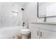 Updated bathroom features marble tile, black fixtures, and a modern vanity at 4857 Fairfax Ave, Las Vegas, NV 89120