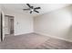 Neutral bedroom showcases a ceiling fan, neutral decor and carpet at 4857 Fairfax Ave, Las Vegas, NV 89120