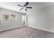 Bedroom with ceiling fan, window, and doorway to the ensuite bathroom at 4857 Fairfax Ave, Las Vegas, NV 89120