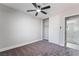 Bright bedroom features new gray carpet, white walls and closet with ceiling fan at 4857 Fairfax Ave, Las Vegas, NV 89120