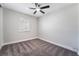 Bedroom boasts a ceiling fan, neutral decor, and window for natural light at 4857 Fairfax Ave, Las Vegas, NV 89120