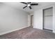 This bedroom features gray carpet and a ceiling fan at 4857 Fairfax Ave, Las Vegas, NV 89120