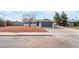 Charming single-story home featuring gray paint, desert landscaping, and a two-car garage at 4857 Fairfax Ave, Las Vegas, NV 89120