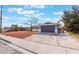 Single story home with desert landscaping and a two car garage on a partly cloudy day at 4857 Fairfax Ave, Las Vegas, NV 89120