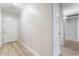 Well lit hallway features neutral walls and wood-look flooring at 4857 Fairfax Ave, Las Vegas, NV 89120