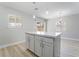 Kitchen island provides additional workspace and seating with view of backyard at 4857 Fairfax Ave, Las Vegas, NV 89120