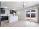 Open-concept kitchen boasts dark cabinets, white subway tile, and stainless steel appliances at 4857 Fairfax Ave, Las Vegas, NV 89120