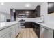Kitchen showcases updated appliances, dark cabinets, and white subway tile backsplash at 4857 Fairfax Ave, Las Vegas, NV 89120
