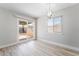 Bright living room with sliding glass doors and wood-look flooring at 4857 Fairfax Ave, Las Vegas, NV 89120