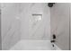 Close up of shower featuring marble tile and a matte black showerhead at 4857 Fairfax Ave, Las Vegas, NV 89120