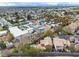 Wide aerial view of a residential neighborhood featuring palm trees and a community pool at 5050 Secret Rock St, Las Vegas, NV 89122
