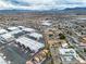 Spacious aerial view highlighting commercial buildings next to the residences, with mountain backdrop at 5050 Secret Rock St, Las Vegas, NV 89122